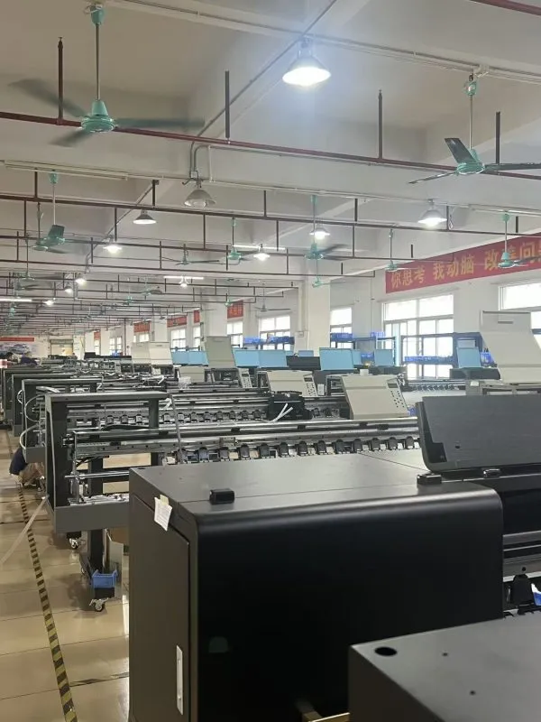 Factory technician inspecting a configured digital textile printer